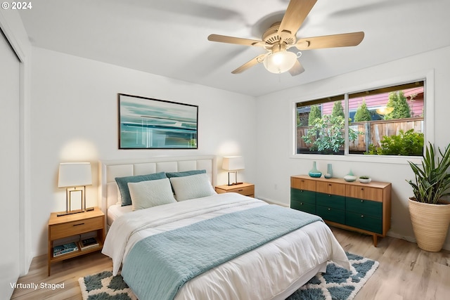 bedroom with ceiling fan, a closet, multiple windows, and light hardwood / wood-style flooring