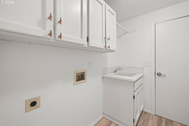 laundry room with cabinets, washer hookup, sink, hookup for an electric dryer, and light hardwood / wood-style flooring