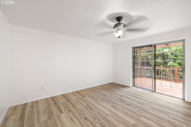 unfurnished room with light wood-type flooring and ceiling fan