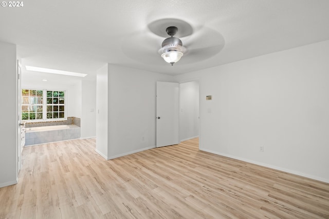 unfurnished room featuring ceiling fan and light wood-type flooring