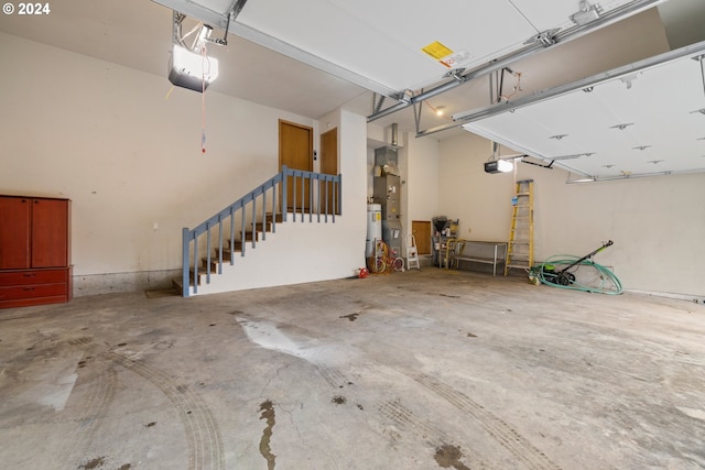 garage with water heater and a garage door opener