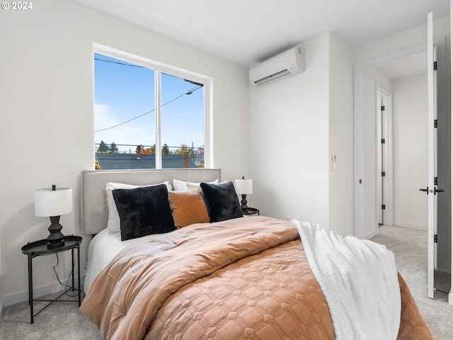 bedroom with a water view, light carpet, and a wall unit AC