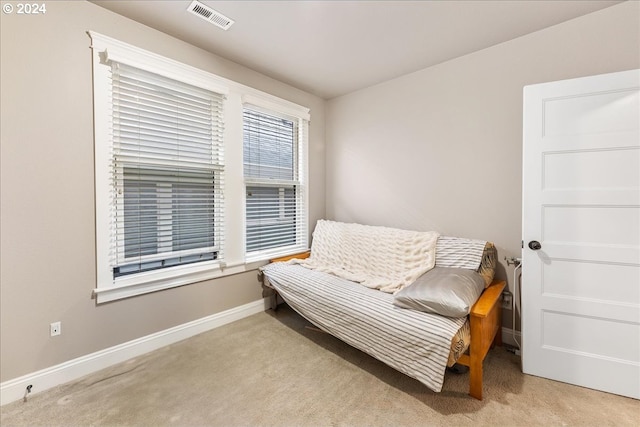 sitting room featuring light colored carpet