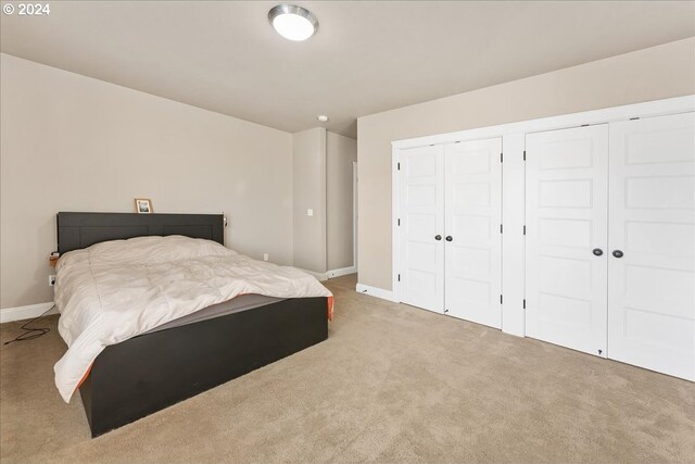 bedroom featuring light carpet