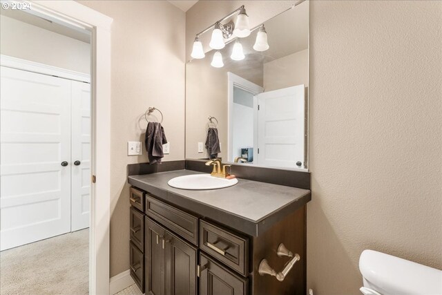 full bathroom with toilet, combined bath / shower with glass door, tile patterned floors, and vanity