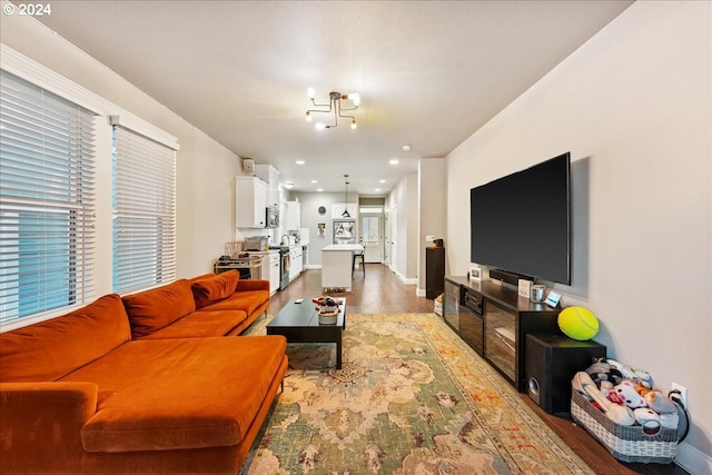 living room with light hardwood / wood-style floors and a chandelier