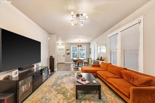 living room featuring wood-type flooring and a chandelier