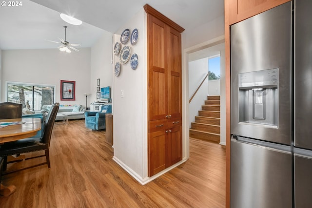 kitchen with ceiling fan, light hardwood / wood-style floors, lofted ceiling, and stainless steel refrigerator with ice dispenser