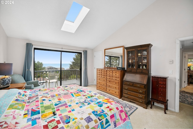 carpeted bedroom with access to exterior, high vaulted ceiling, and a skylight