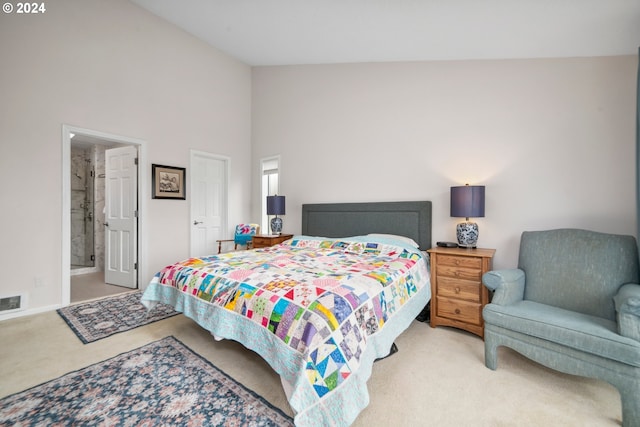 bedroom featuring connected bathroom, high vaulted ceiling, and carpet floors