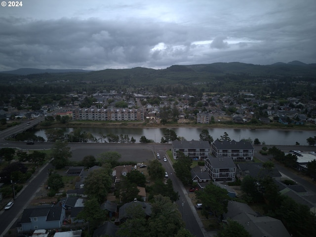 drone / aerial view featuring a water and mountain view