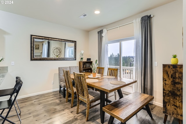 dining area with hardwood / wood-style flooring