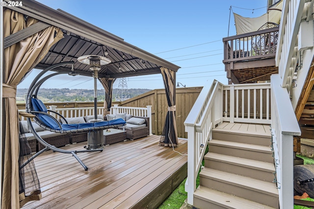 wooden terrace with an outdoor living space