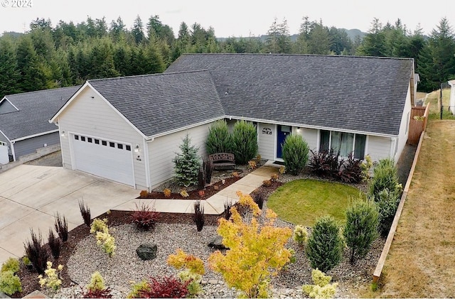 single story home with a garage, a front yard, concrete driveway, and roof with shingles