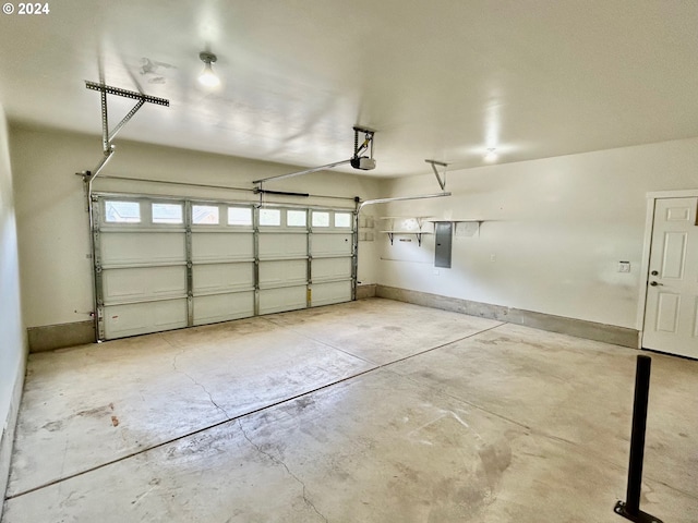 garage with a garage door opener, electric panel, and baseboards