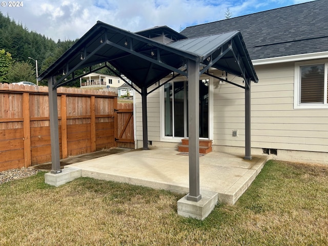 view of patio / terrace featuring a gazebo, fence, and a gate