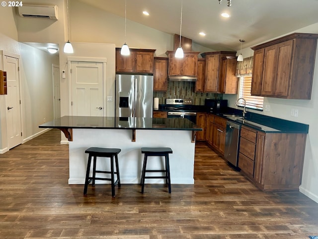 kitchen with appliances with stainless steel finishes, dark countertops, and pendant lighting