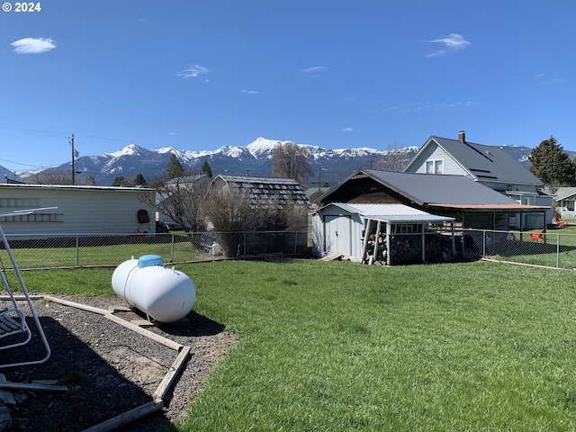 view of yard featuring a mountain view and a shed