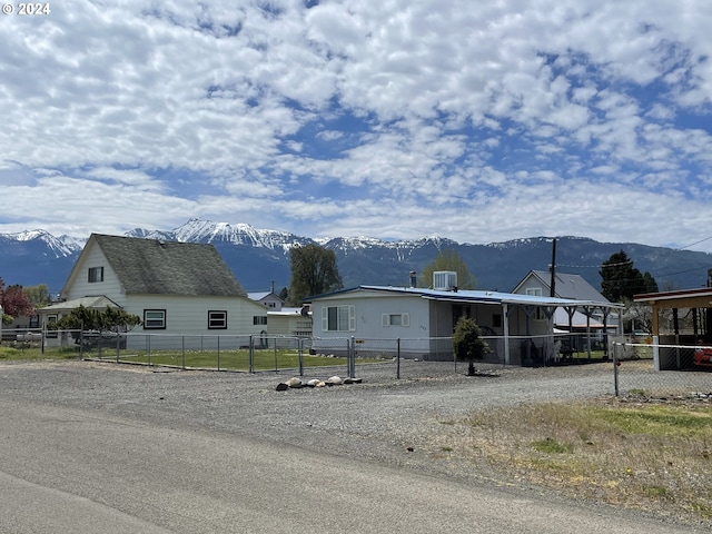 view of front facade with a mountain view and central air condition unit