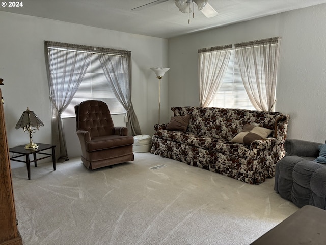 living room featuring carpet flooring and ceiling fan