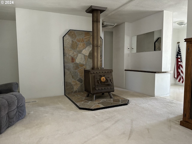 carpeted living room featuring a wood stove