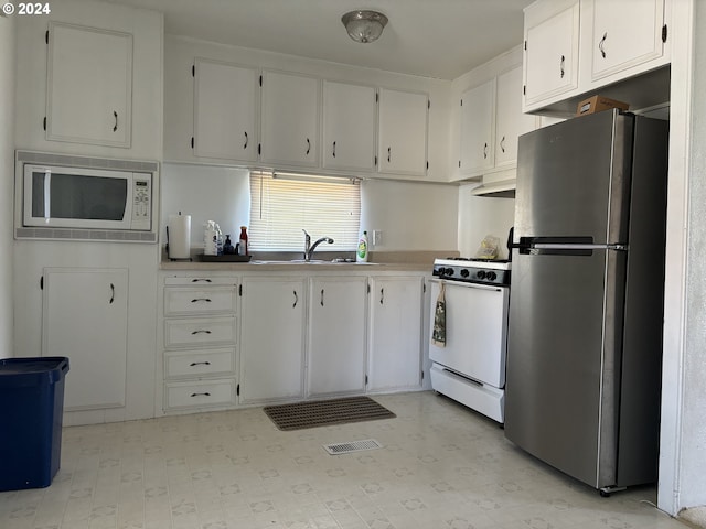 kitchen with white cabinets, white appliances, and sink