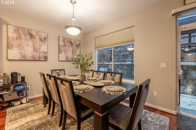 dining space with dark hardwood / wood-style floors