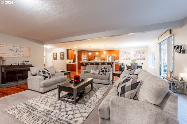 living room featuring a textured ceiling and light hardwood / wood-style flooring