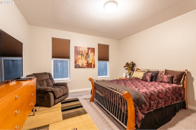 carpeted bedroom featuring a textured ceiling