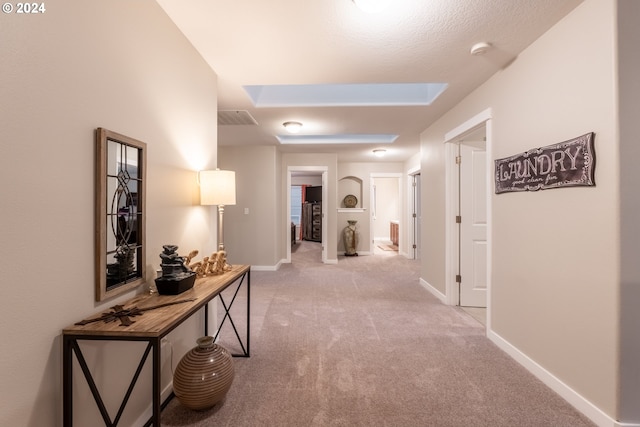 hallway featuring light carpet