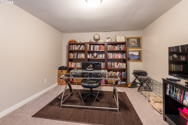 home office with a textured ceiling and carpet flooring