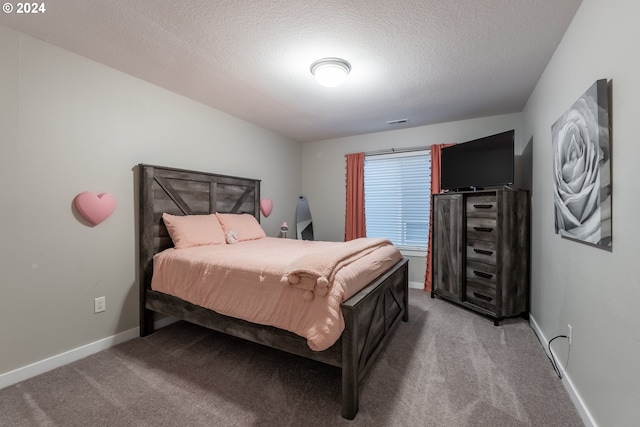 carpeted bedroom with a textured ceiling