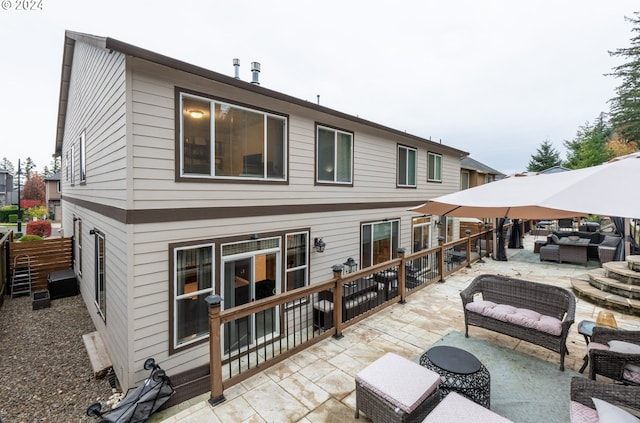 back of house featuring a patio and outdoor lounge area