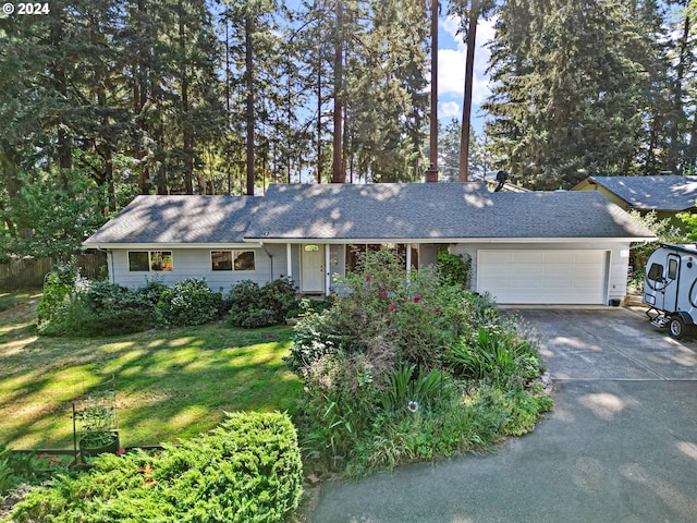 ranch-style home featuring a front lawn and a garage