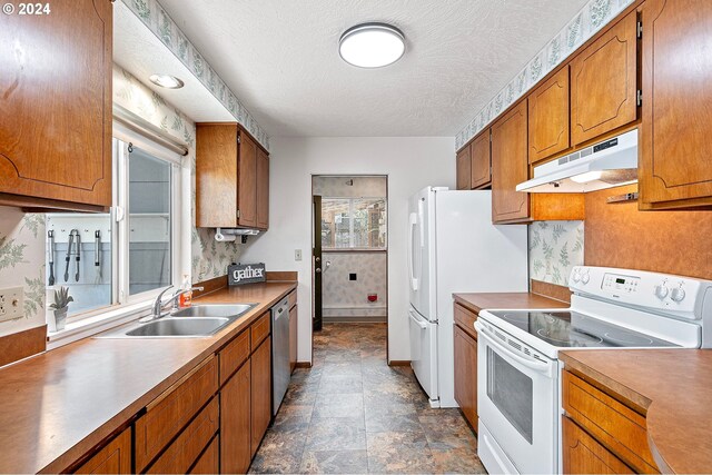 kitchen featuring a textured ceiling, sink, white range with electric stovetop, and plenty of natural light