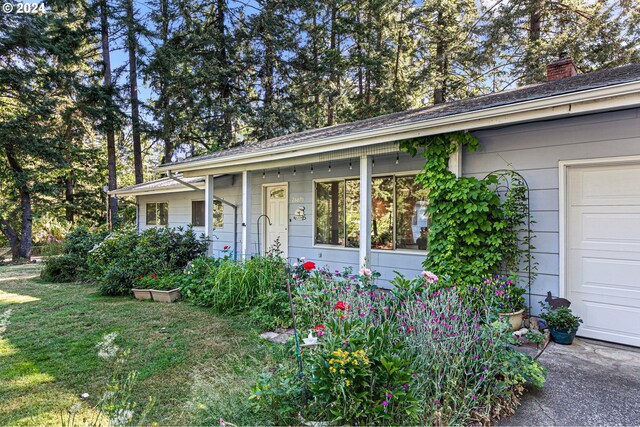 ranch-style home featuring a garage and a front lawn