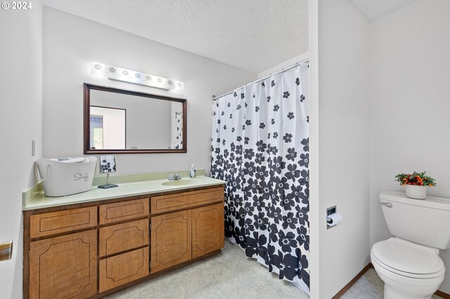 bathroom featuring vanity, toilet, a textured ceiling, and curtained shower