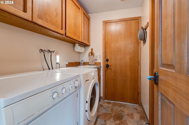 laundry area featuring cabinets, sink, and washing machine and dryer