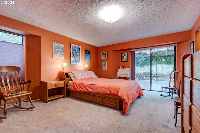 bedroom featuring light carpet, access to exterior, and a textured ceiling