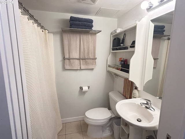 bathroom with toilet, tile patterned flooring, walk in shower, and sink