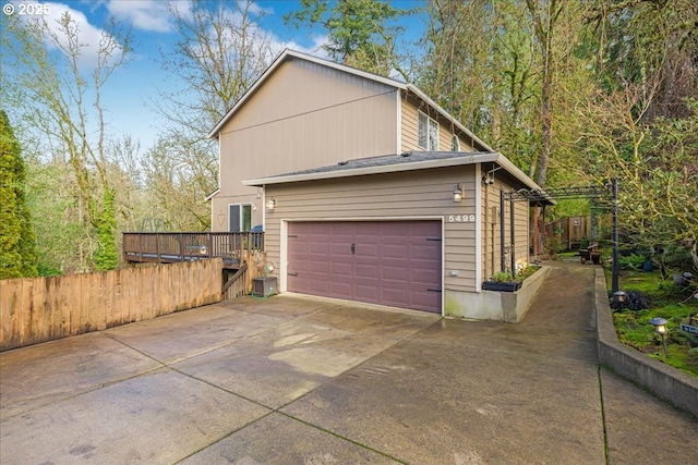 view of property exterior featuring a garage and cooling unit