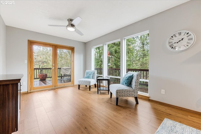 sitting room with light hardwood / wood-style flooring and ceiling fan