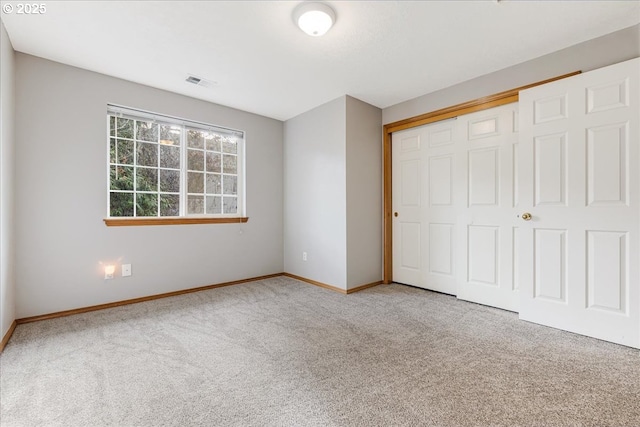 unfurnished bedroom featuring carpet floors and a closet