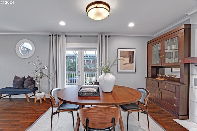 dining room with dark hardwood / wood-style flooring, crown molding, and french doors