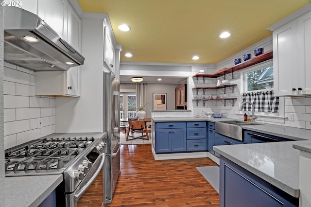 kitchen featuring decorative backsplash, appliances with stainless steel finishes, extractor fan, sink, and white cabinetry