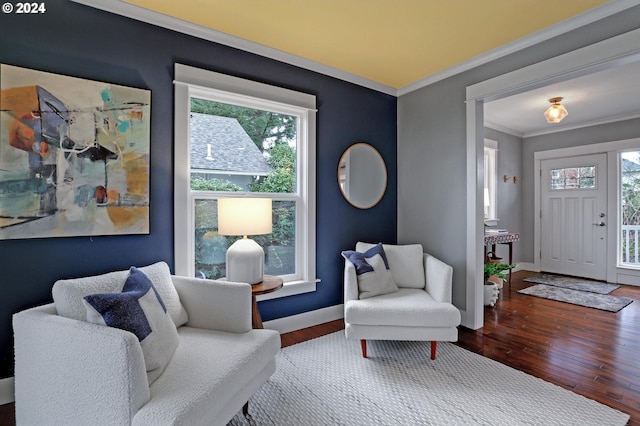 sitting room with hardwood / wood-style floors and ornamental molding