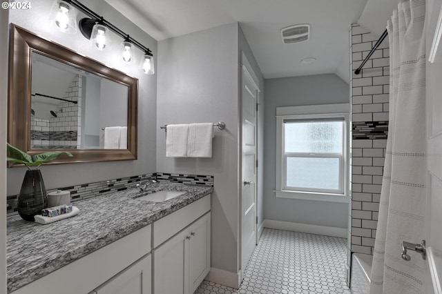 bathroom featuring vanity, shower / bath combination with curtain, and decorative backsplash