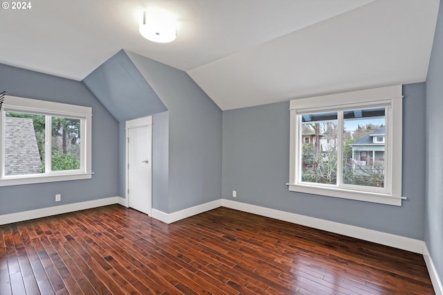 additional living space with dark hardwood / wood-style flooring and lofted ceiling