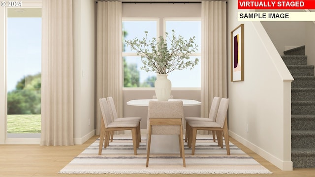 dining space featuring hardwood / wood-style flooring and a wealth of natural light