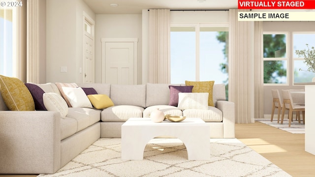 living room featuring plenty of natural light and light wood-type flooring